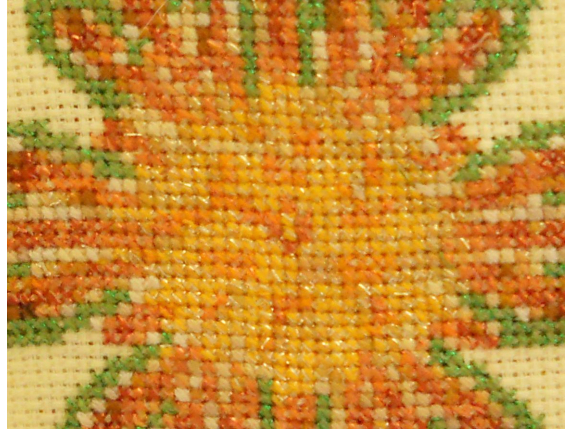 center close up sunflower sunburst stitched design